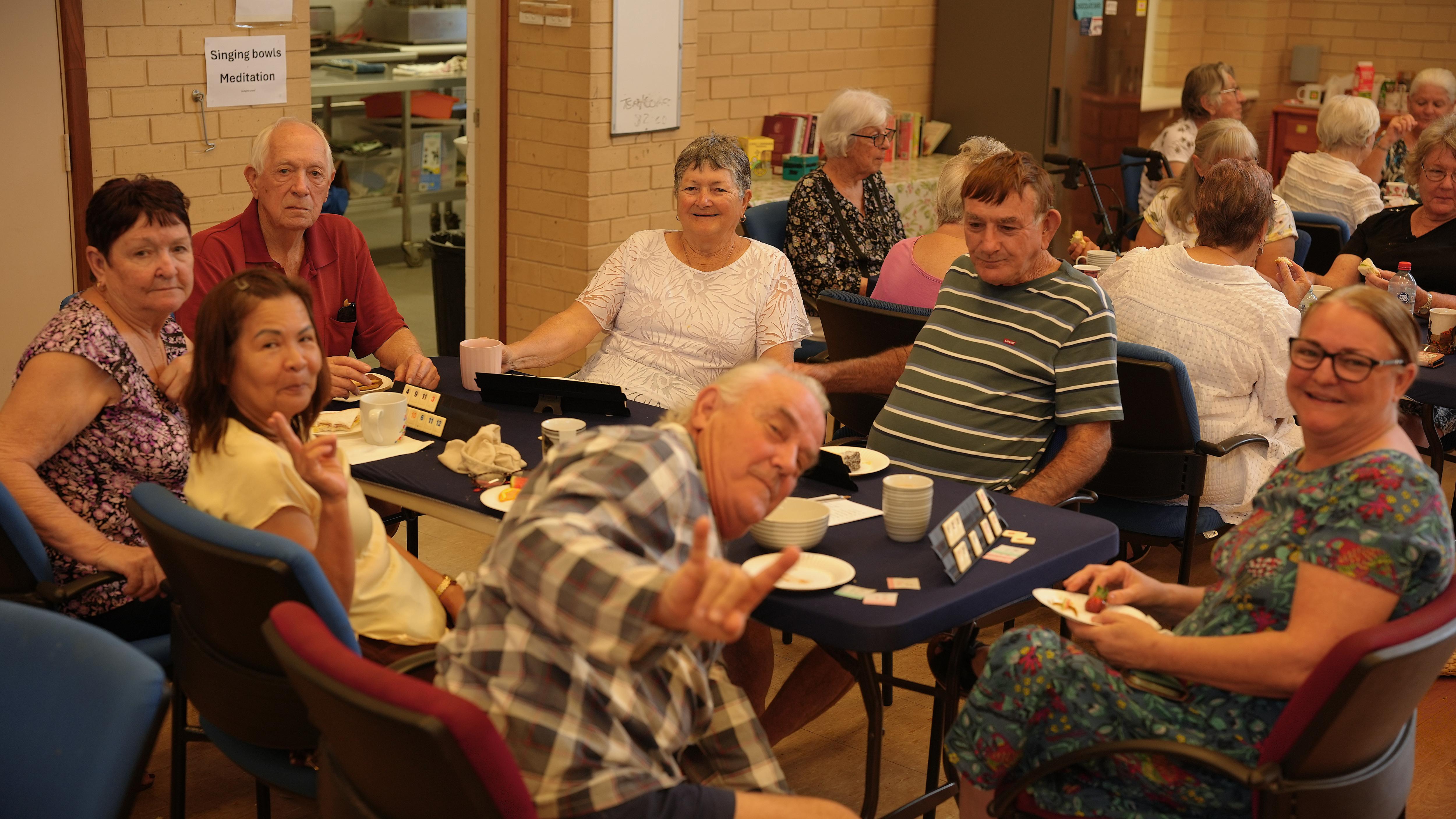 Carnarvon Old Bastards members sitting around table having morning tea and playing games.