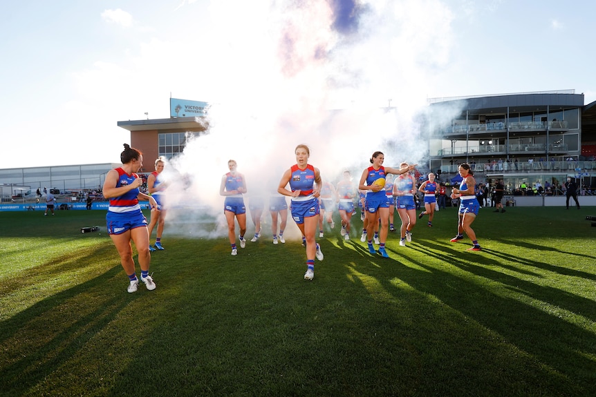 The Bulldogs AFLW side runs onto Whitten Oval at the start of season six 2022