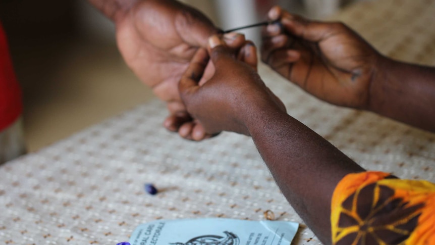 Vanuatu voter gets inked after voting.