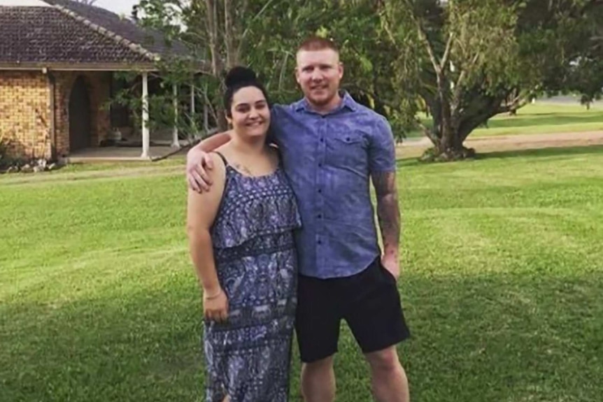 A man and a woman smile at the camera