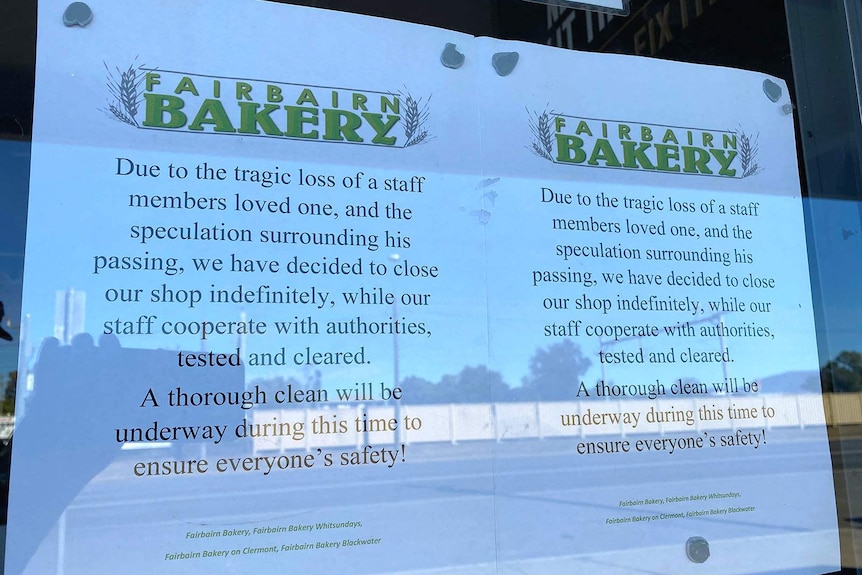 A sign in the window of a bakery