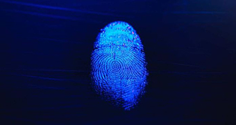 The mark of a fingerprint, highlighted in light blue, is suspended against a dark blue background.