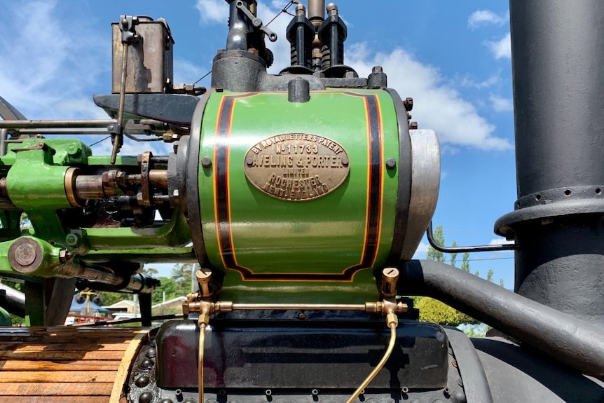 A shiny green engine, with a brass plate featuring old Aveling and Porter insignia.
