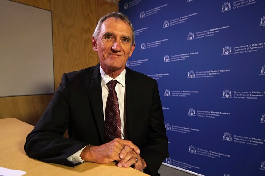 David Hillyard sits in front of a blue WA Government Department of Commerce Consumer Protection screen.