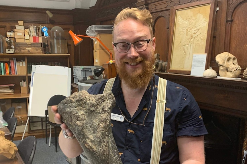 Dr David Waterhouse from Norfolk Museums with the leg bone of a woolly mammoth