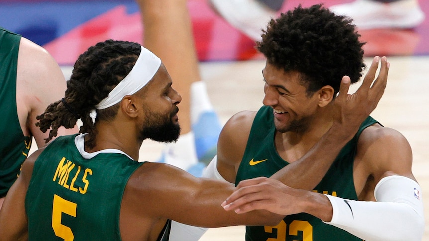 Two Boomers players celebrate during a game before the Tokyo Olympics in 2021.