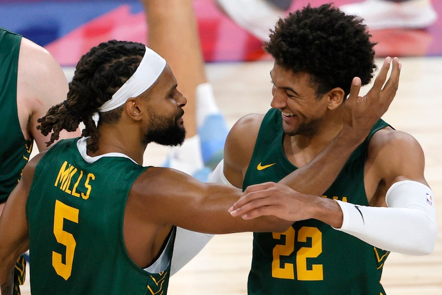 Two Boomers players celebrate during a game before the Tokyo Olympics in 2021.