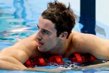 James Magnussen rests on the lane rope after coming second in the men's 100m freestyle final.