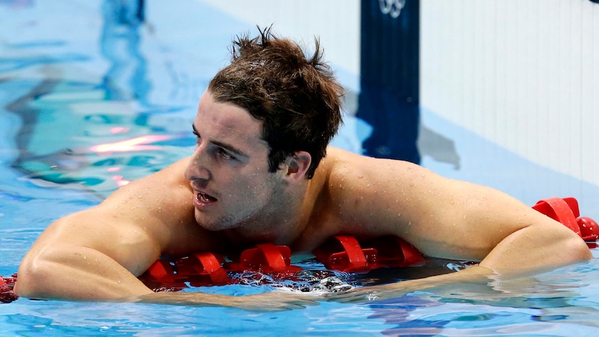 James Magnussen rests on the lane rope after coming second in the men's 100m freestyle final.