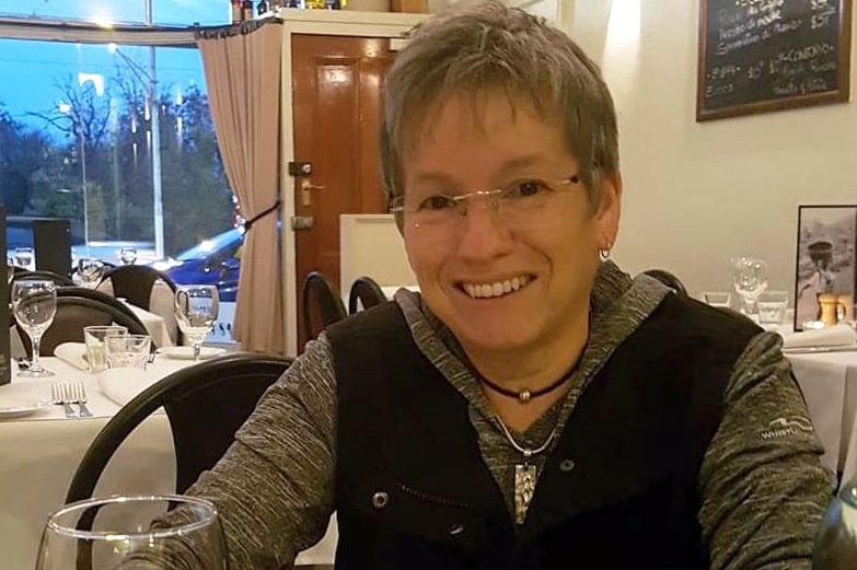 Cynthia Kerr sitting at a table in a restaurant.