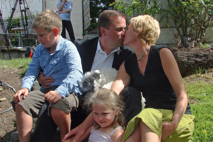 David Bartlett kisses wife Larissa after a media conference announcing his resignation.