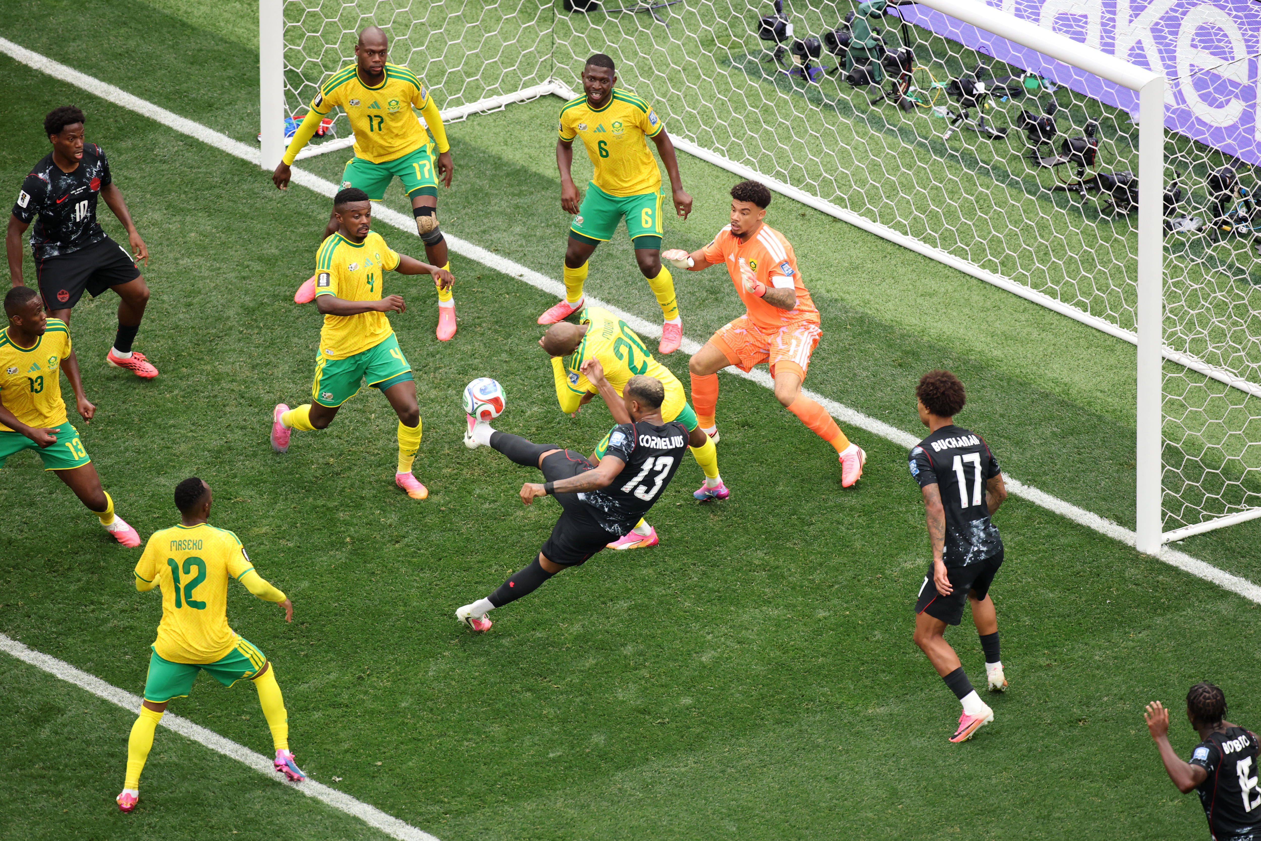 Derek Cornelius shoots at a maze of players