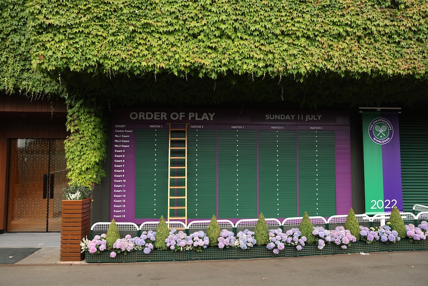 A board stands at Wimbledon with the heading 'Order of play', a list of courts and columns marked 'match 1' to 'match 5'. 