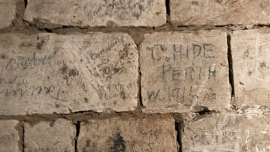 Etchings on the brick walls of ancient tunnels.