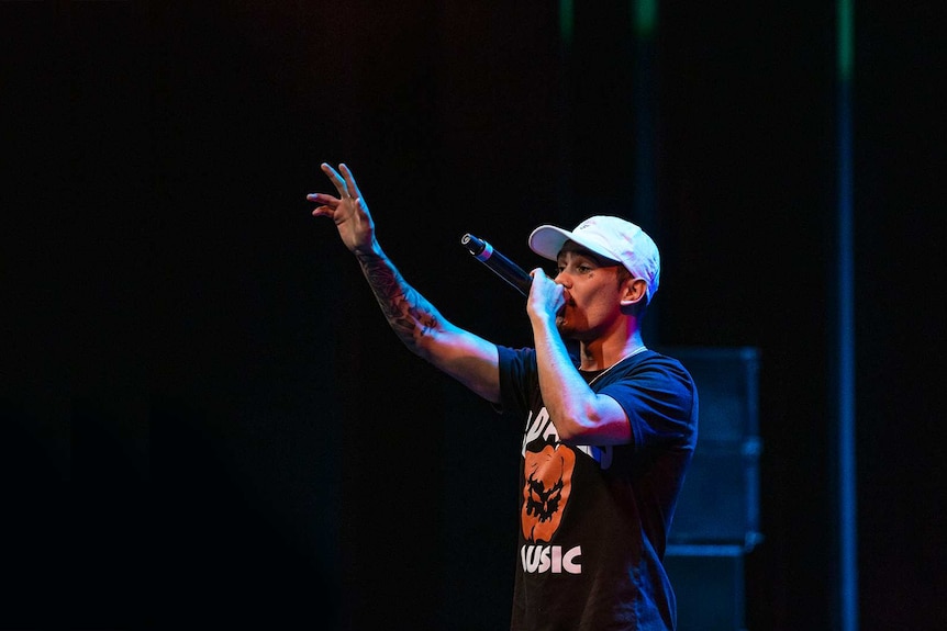 Colour photo of rapper Kobie Dee performing on stage at Sydney Opera House.