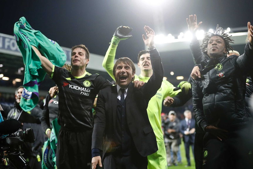 Antonio Conte celebrates Chelsea's Premier League triumph with his players.