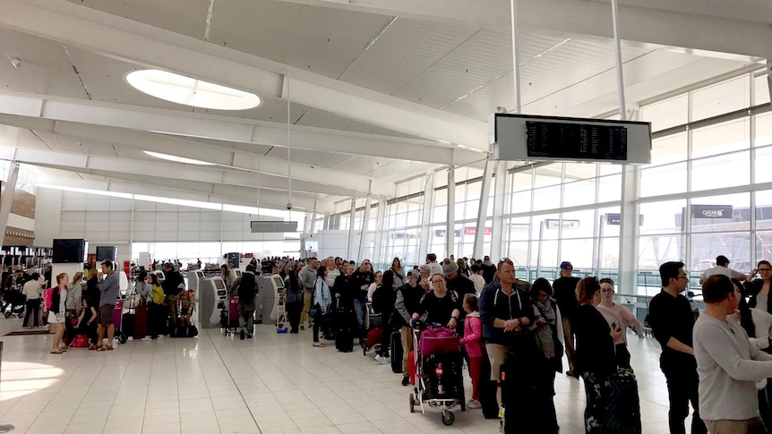 A long line of passengers at Adelaide Airport.
