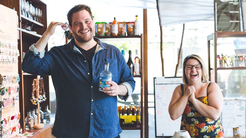 Pop CBR owners Gabe Trew and Mikhaila Pennell laughing in their colourful store.