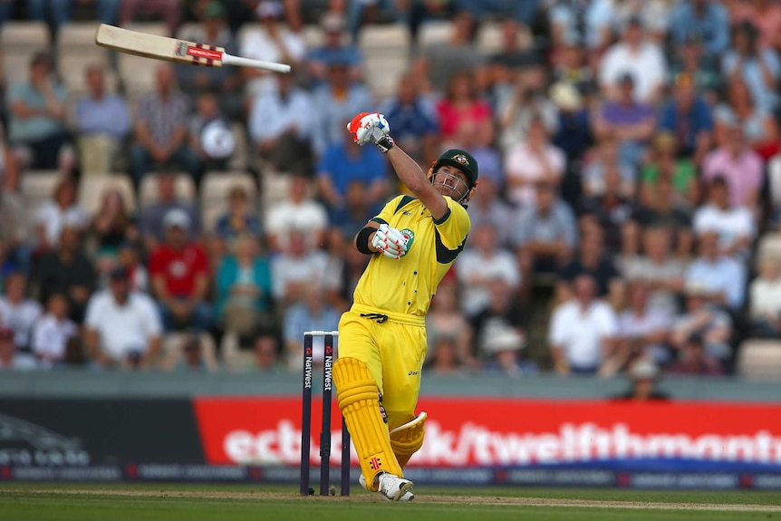 Austalia's David Warner lets go of his bat as he gets out in the T20 international against England.