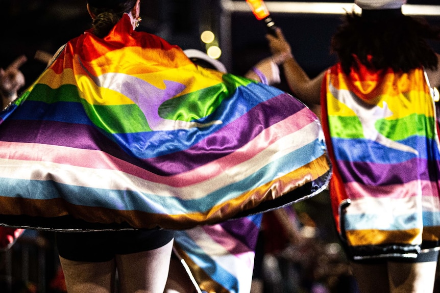 people wearing the rainbow flag