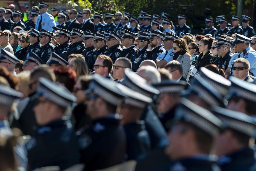 Police and guests grieve outside the Clive Berghofer Recreational Centre during the funeral for Senior Constable Brett Forte