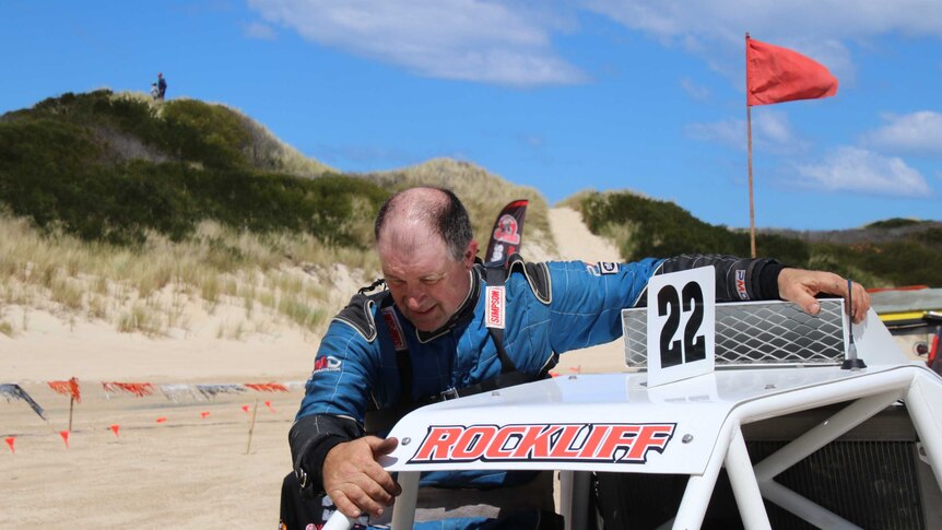 Scott Rockliff climbs out of his dune buggy.