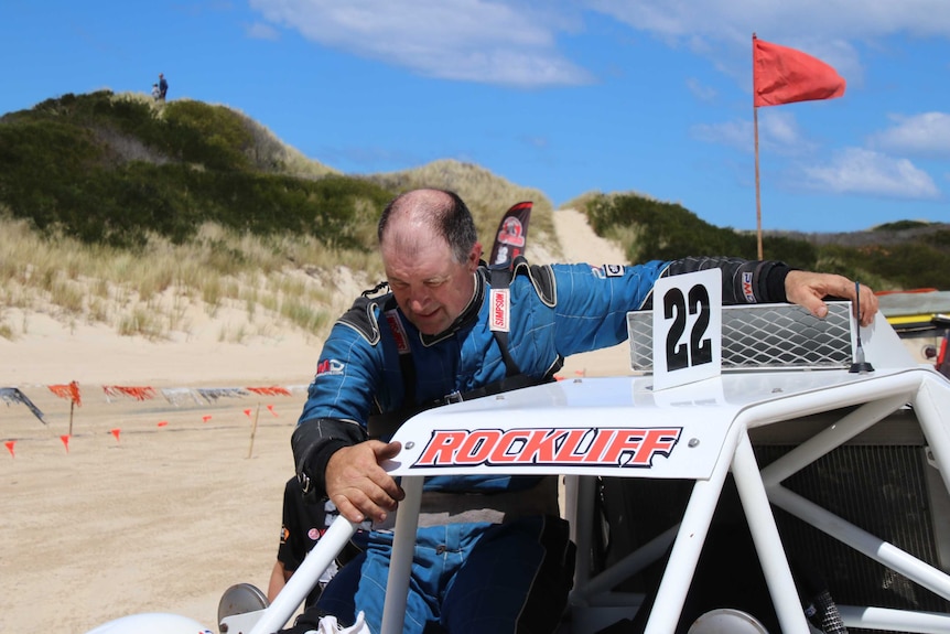 Scott Rockliff climbs out of his dune buggy.