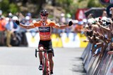 Richie Porte celebrates on Willunga Hill as he crosses the line to win stage five of the Tour Down Under