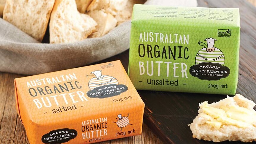Two blocks of organic butter in front of a small sack of scones