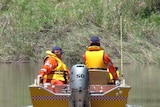 An SES crew make their way through floodwaters