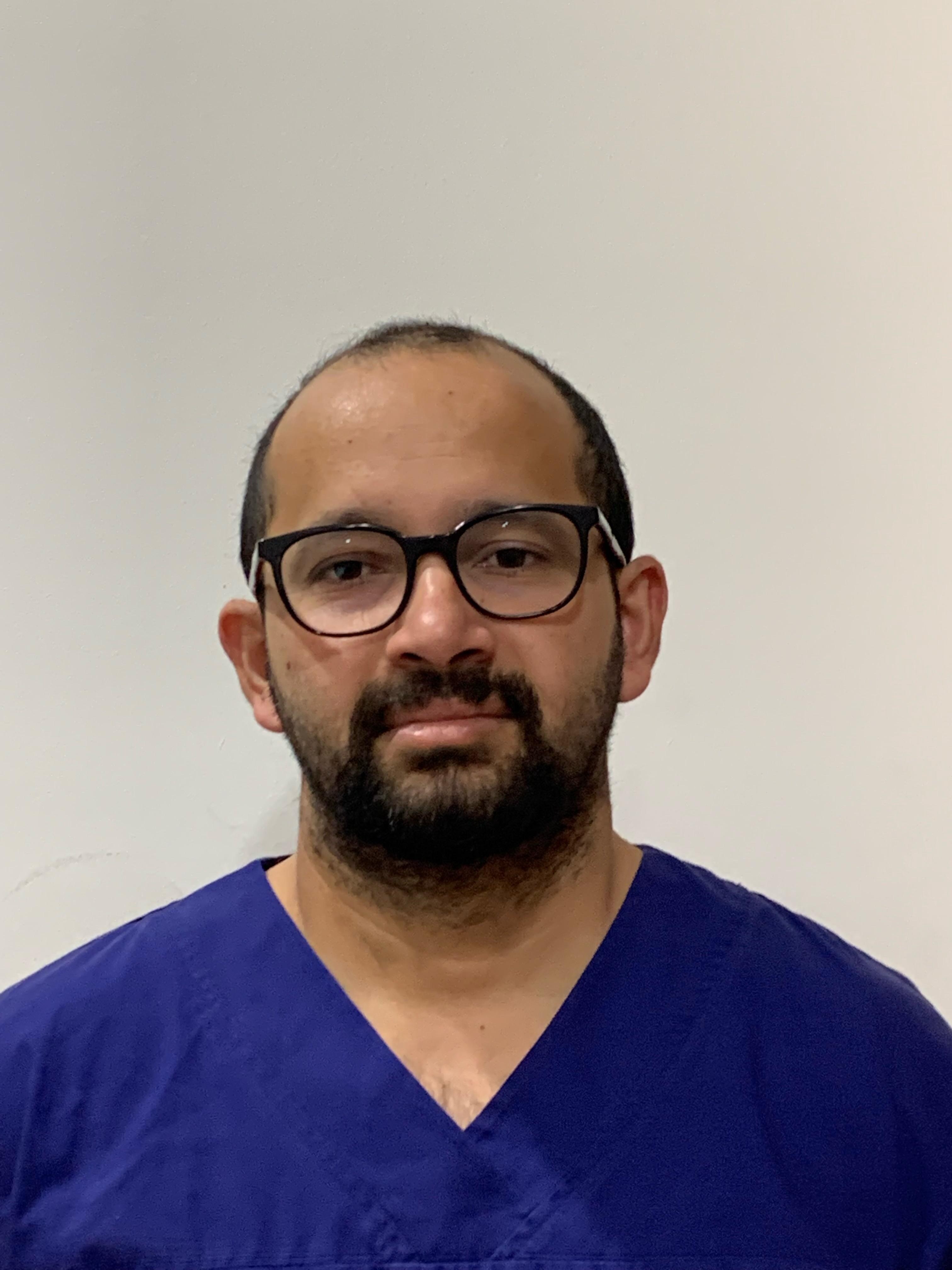 A man in nurses scrubs 