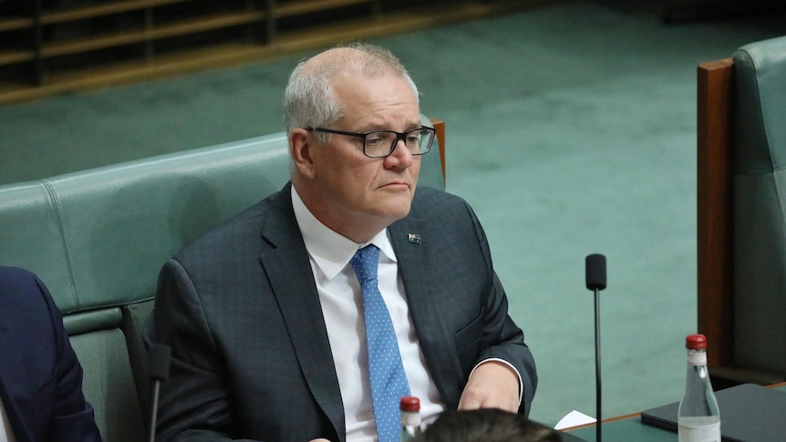 Scott Morrison sitting on the backbench in parliament house 