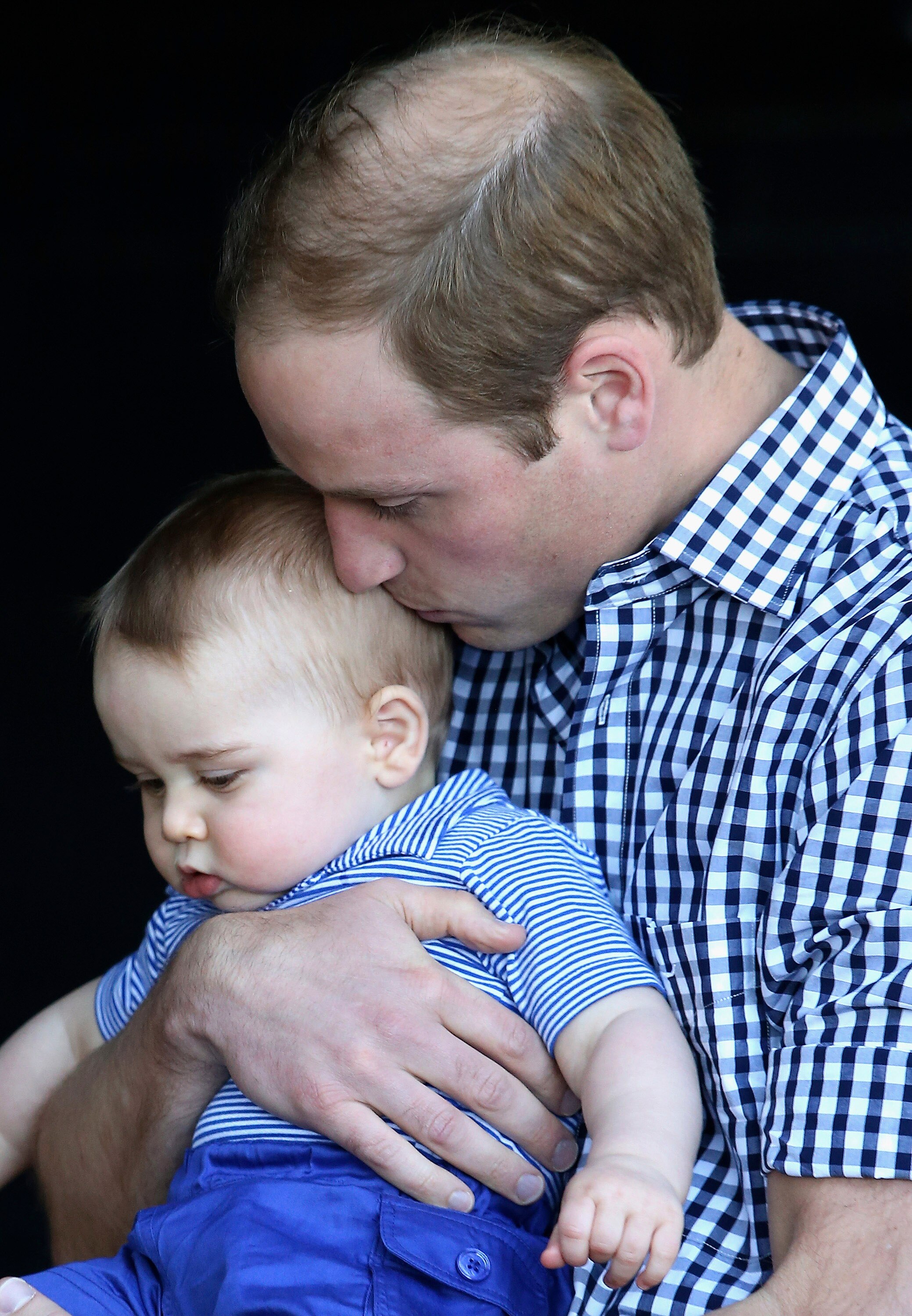 Britain's Prince William kisses his son Prince George.