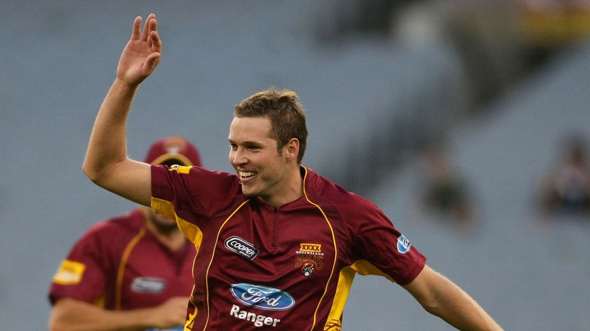 Queensland's Ben Laughlin celebrates the wicket of Victoria's David Hussey.