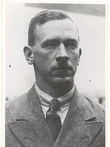 A profile of Percy Stephensen with a hair cut and moustache bearing a likeness of Adolf Hitler