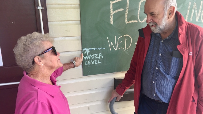 woman and man chat outside flood meeting