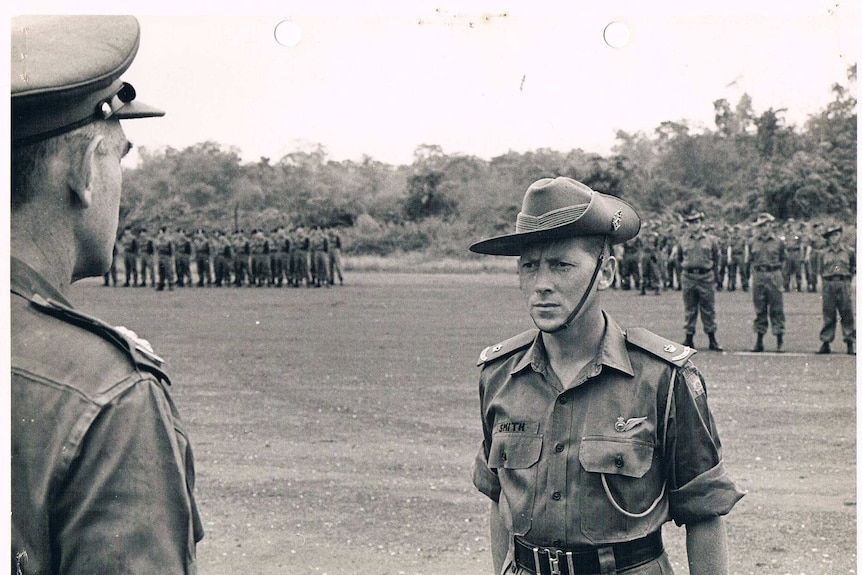 A black-and-white photo of a young army soldier in the 1970s.