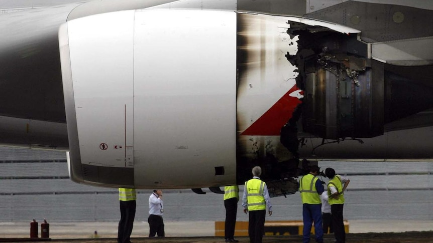 Technicians look at exploded Qantas engine (Reuters: David Loh)