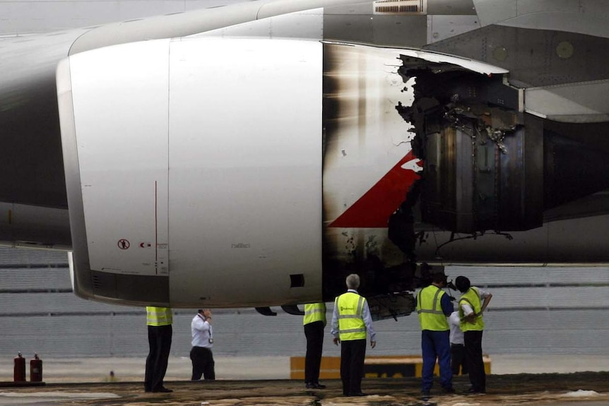 Technicians look at exploded Qantas engine (Reuters: David Loh)