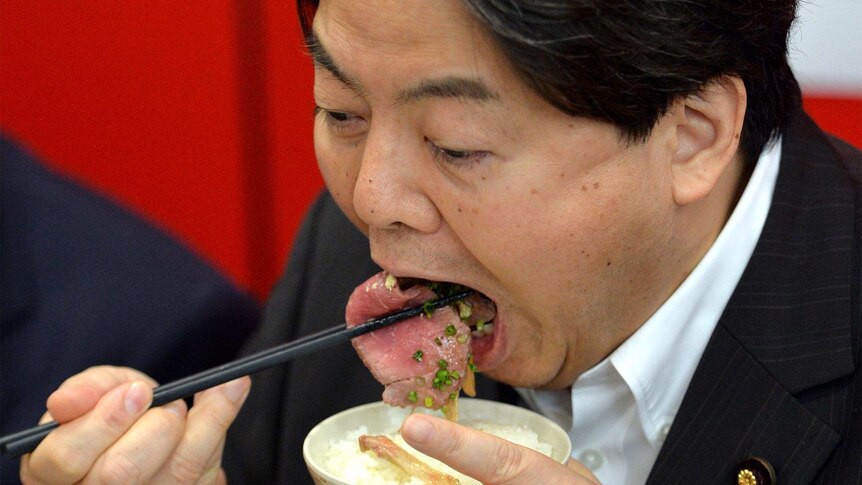 Japanese Agriculture Minister Yoshimasa Hayashi eats whale meat during a promotion in Tokyo.