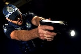 Queensland police officer Clinton Mair demonstrates weapon-mounted light