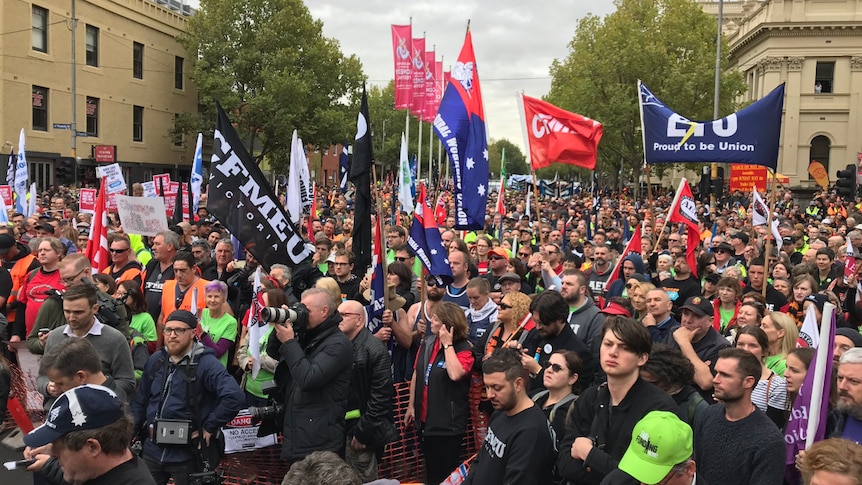 Hundreds of union members spread over an intersection.