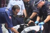 Paramedics work on a teen shot by police in the Sydney suburb of Kings Cross.