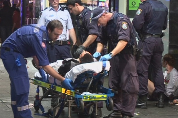 Paramedics work on a teen shot by police in the Sydney suburb of Kings Cross.