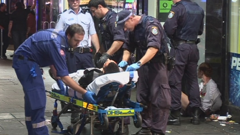 Paramedics work on a teen shot by police in the Sydney suburb of Kings Cross.