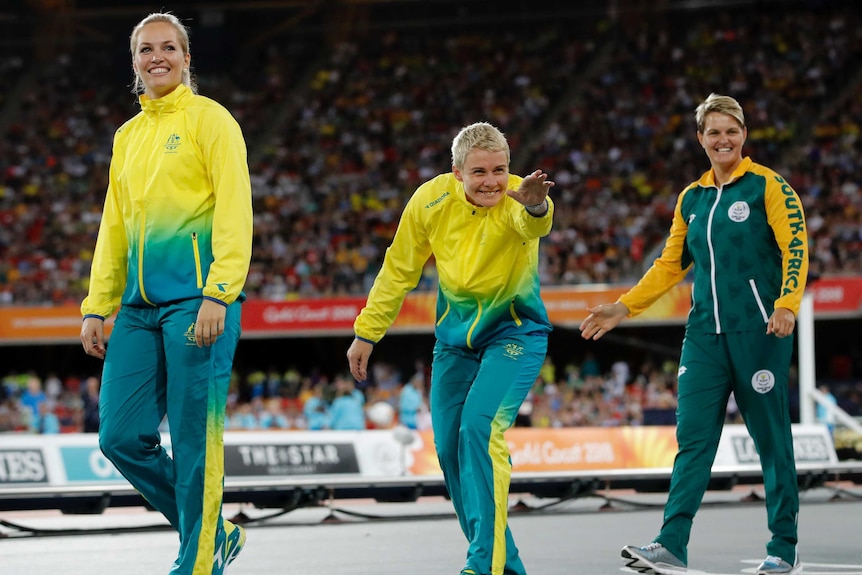 Australia's Kathryn Mitchell (C) gestures to crowd with Kelsey-Lee Roberts (L) and Sunette Viljoen.