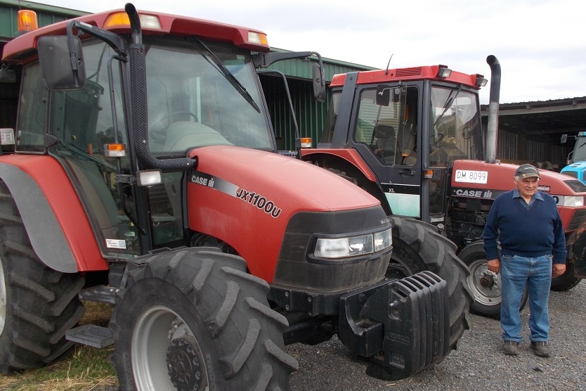 Man stands with tractors