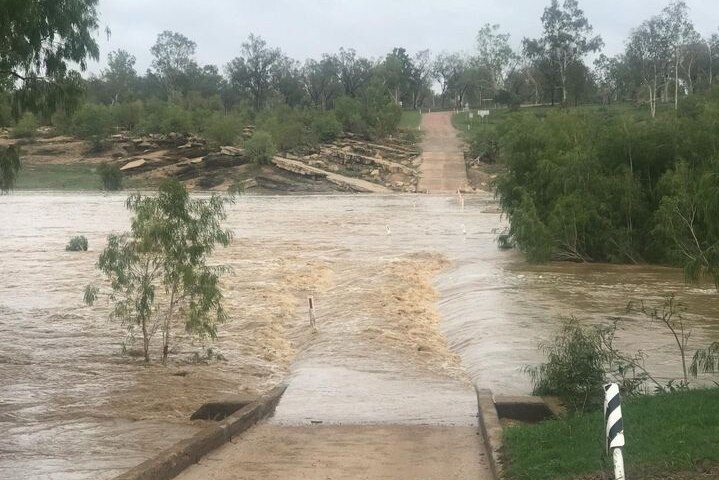 Rushing water over a bridge.