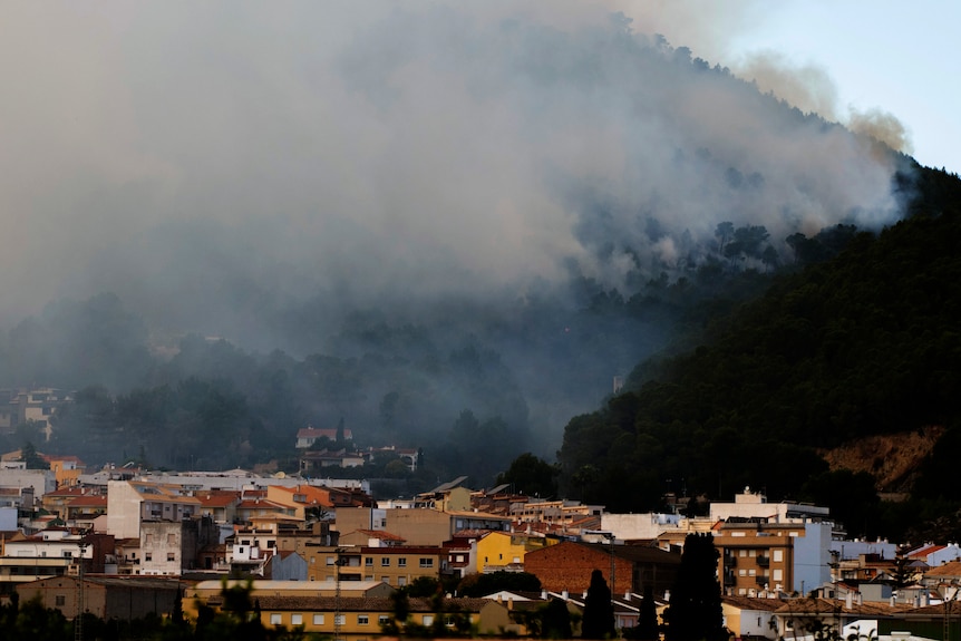 Smoke rises over the town of Montitxelvo