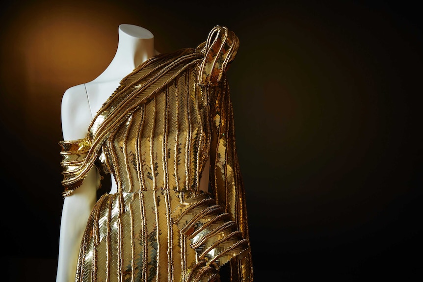 A detailed gold sequined dress.